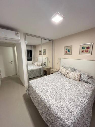 a bedroom with a bed and a large mirror at Apartamento en Edificio Chronos in Punta del Este