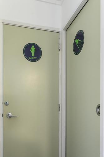 a door with a sign on it next to another door at Urban Lounge Sleepery in Rotorua