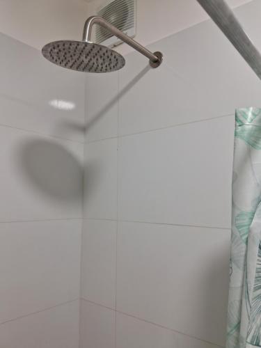 a shower with a shower head in a bathroom at Habitación Nueva Pareja o sola in Lima