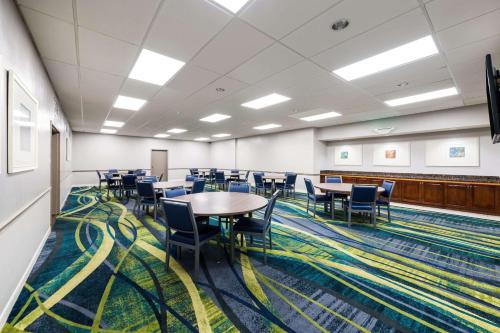 a conference room with tables and chairs on a carpet at Country Inn & Suites by Radisson, Virginia Beach Oceanfront , VA in Virginia Beach