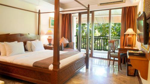 a bedroom with a bed and a balcony at Lorin Solo Hotel in Solo