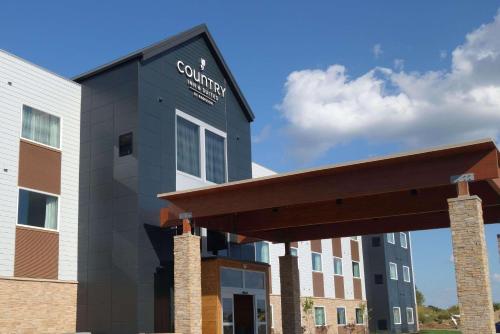 a building with a sign on the side of it at Country Inn & Suites by Radisson, Ft Atkinson, WI in Fort Atkinson