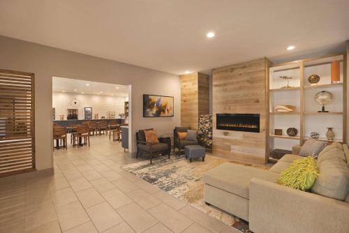 a living room with a couch and a dining room at Country Inn & Suites by Radisson, Green Bay North in Green Bay