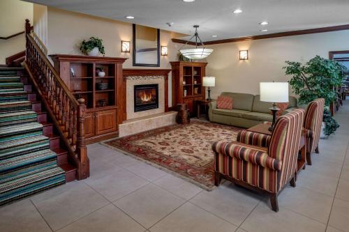 a living room with a couch and a fireplace at Country Inn & Suites By Radisson, Charleston South, WV in Charleston