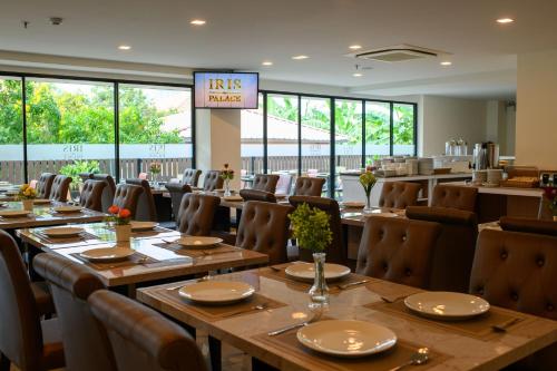 a dining room with wooden tables and chairs at IRIS PALACE in Pattaya South