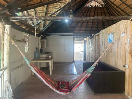 a hammock in a room in a barn at “SandSerenity EcoHostal Punta Arena” in Cartagena de Indias