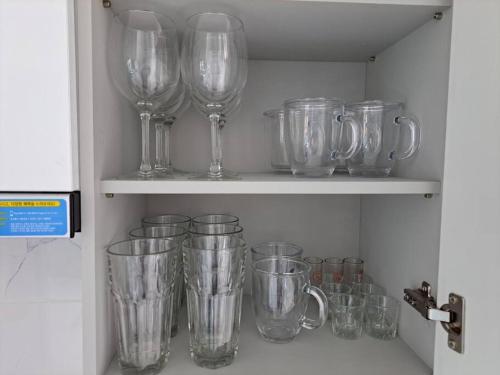 a bunch of glass vases on a shelf at Narae House in Busan
