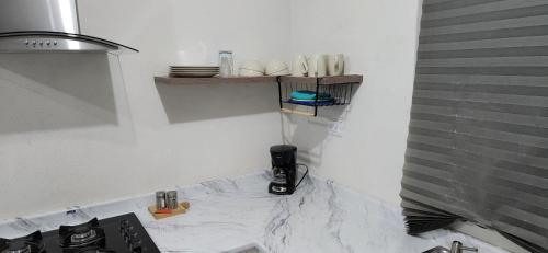 uma cozinha com uma bancada branca e um fogão em Salamanca Residencial em Hermosillo