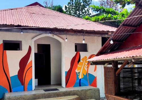 a building with a mural on the side of it at Leynes Taal Lake Resort and Hostel in Tanauan