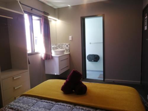 a bedroom with a bed and a sink and a mirror at The Duke Hostel in Greymouth