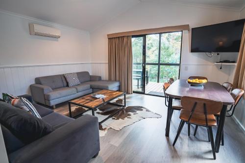 a living room with a couch and a table at BIG4 Tassie Getaway Parks St Helens in St Helens