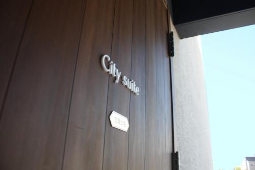 a wooden door with a city sign on it at Hotel Dios - Vacation STAY 31424v in Awaji