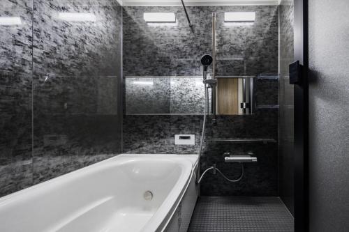 a bathroom with a bath tub and a shower at Hotel Dios - Vacation STAY 40406v in Awaji