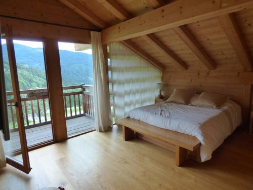 a bedroom with a bed in a room with windows at Chalet Le Grand-Bornand, 7 pièces, 10 personnes - FR-1-458-193 in Le Grand-Bornand