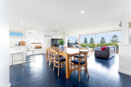 a kitchen and dining room with a table and chairs at Stoneferry- A Beachfront Beauty - Free Wifi in Port Elliot