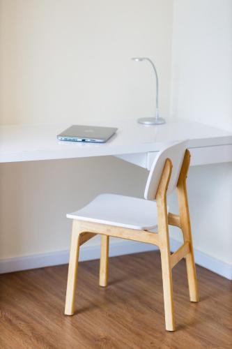 a desk with a chair and a laptop on it at TUI BLUE Nha Trang in Nha Trang