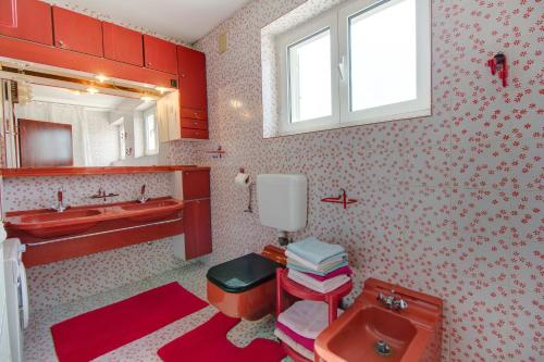 a bathroom with a sink and a toilet and a mirror at Apartment Mario in Mali Lošinj
