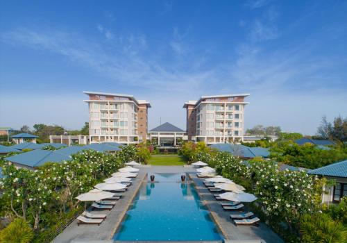 an aerial view of a resort with a pool and umbrellas at Hoan My Resort - Ninh Chu in Phan Rang–Tháp Chàm