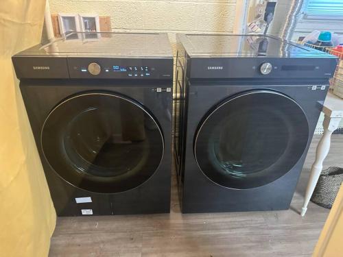 a washing machine and a dryer sitting next to each other at Roomy Oasis DC area pet friendly in Takoma Park