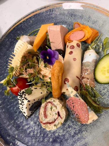 a blue plate with different types of food on it at La Konac in Murighiol