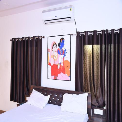 a bedroom with a bed with black curtains at Hotel Ajitgarh in Jhunjhunūn