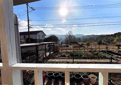 a view of a garden from a balcony at Homey Inn Enya in Yufuin