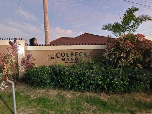 a building with a sign that reads the college of manager at The Surada Bay 2 bedrooms in Old Harbour