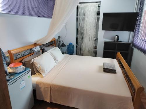 a bedroom with a large bed and a television at Penthouse Crystal Bay Apartments in Ban Lamai