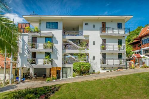an image of a white apartment building with balconies at Penthouse Crystal Bay Apartments in Ban Lamai