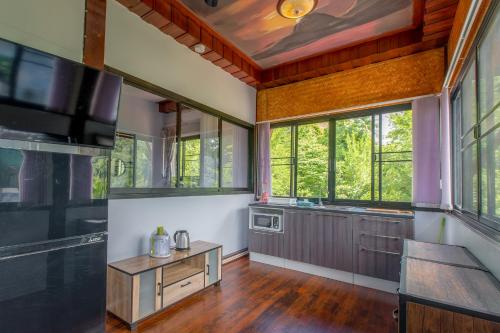 a large kitchen with windows and a table in a room at Penthouse Crystal Bay Apartments in Ban Lamai