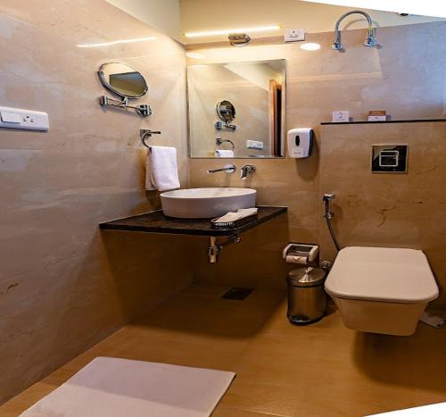 a bathroom with a sink and a toilet at Five Elements Hotels Mertiya Residency in Jodhpur