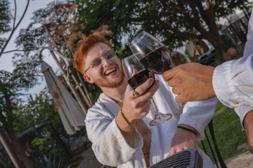 a man is holding a glass of wine at Casa Hala LOFT & SPA LUXURY in León