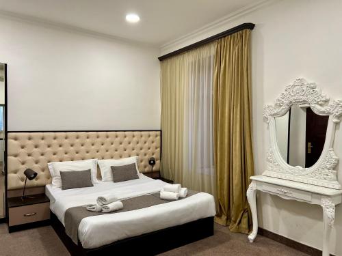 um quarto com uma cama grande e um espelho em YVN Tumanyan apart-hotel em Yerevan