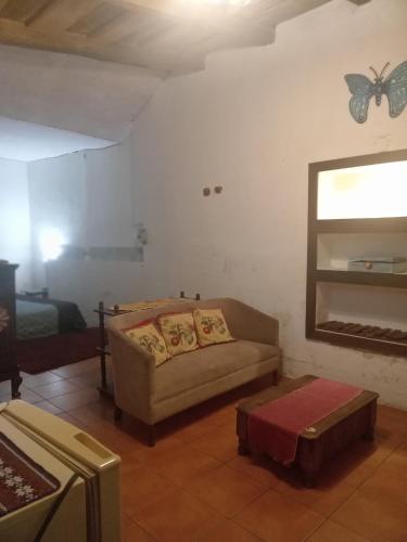 a living room with a couch and a butterfly on the wall at Casa 27 in Antigua Guatemala