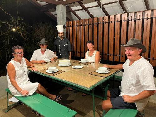 a group of people sitting around a table at Akein Jungle Resort - Sigiriya in Sigiriya