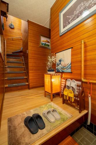a room with wooden walls and a staircase and a room with a room at Jujo house Direct to Shinjuku in Tokyo