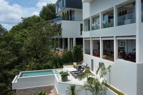 an aerial view of a white building with a swimming pool at Zog Villas in Koh Samui 