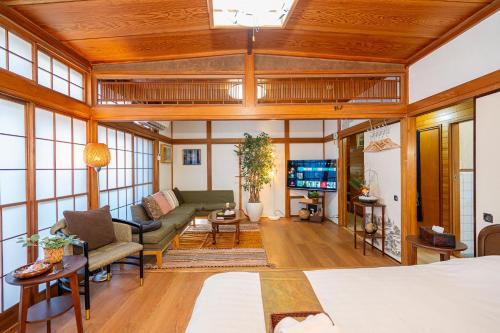 a living room with a couch and a tv at Jujo house Direct to Shinjuku in Tokyo