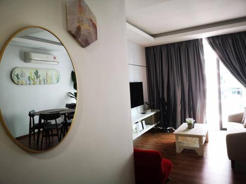 a living room with a mirror and a room with a table at Vivacity Megamall Jazz Suite Kuching 8pax 3BR #Joyoustayz in Kuching