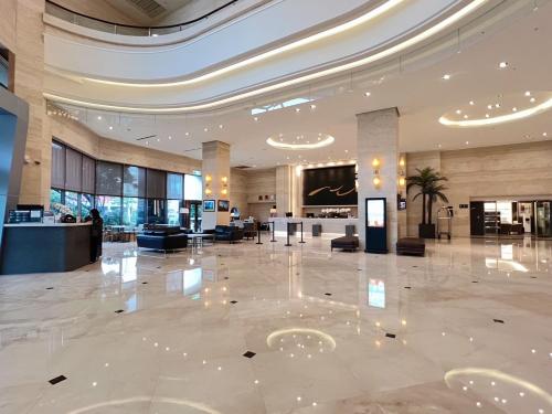 a lobby of a hotel with a large marble floor at Taichung Harbor Hotel in Wuqi