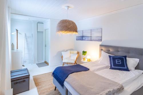a bedroom with a bed and a chair in it at Villa Aurinko Studio Apartment in Hanko in Hanko