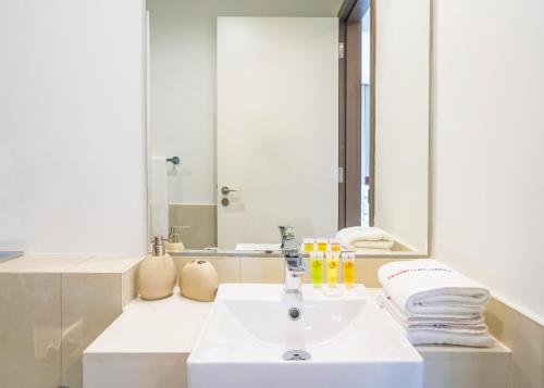 a bathroom with a sink and a mirror at HomesGetaway-2BR Apt in Al Wasl 1 Residences in Dubai