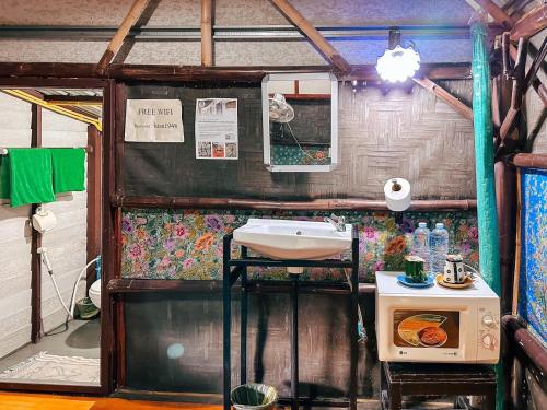 a small bathroom with a sink and a stove at Baan Suanthip Homestay - Aoluek Natural Retreat in Ao Luk