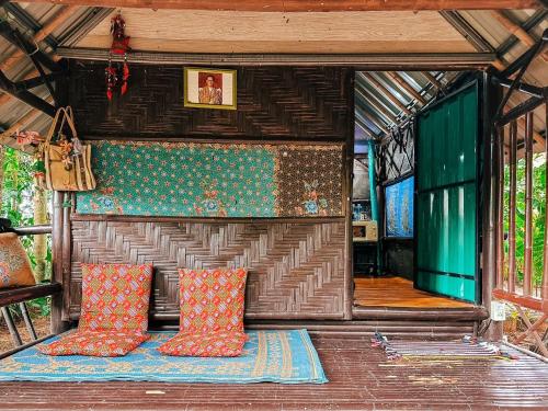 a room with pillows on a couch in a house at Baan Suanthip Homestay - Aoluek Natural Retreat in Ao Luk