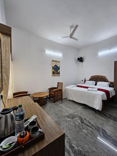 a hotel room with a bed and a table at Lake facing Villa-Water sport activities-Niva Waterways in Vaikom