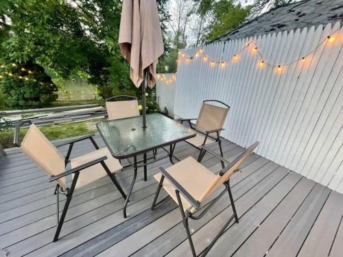 a table and chairs on a deck with an umbrella at Waterfront house near the Niagara Falls/Canal/Canadian Border in Tonawanda