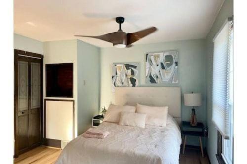 a bedroom with a bed with a ceiling fan at Waterfront house near the Niagara Falls/Canal/Canadian Border in Tonawanda