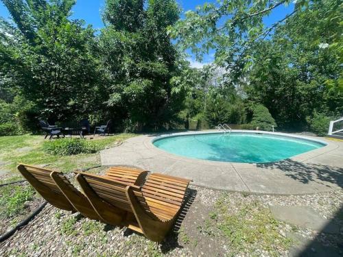 a wooden bench sitting next to a swimming pool at Waterfront house near the Niagara Falls/Canal/Canadian Border in Tonawanda