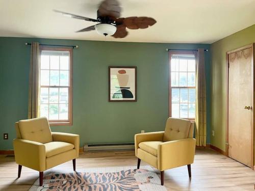 a living room with two chairs and a ceiling fan at Waterfront house near the Niagara Falls/Canal/Canadian Border in Tonawanda