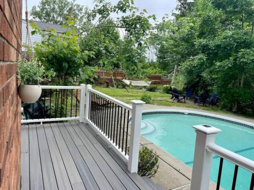a wooden deck next to a swimming pool at Waterfront house near the Niagara Falls/Canal/Canadian Border in Tonawanda